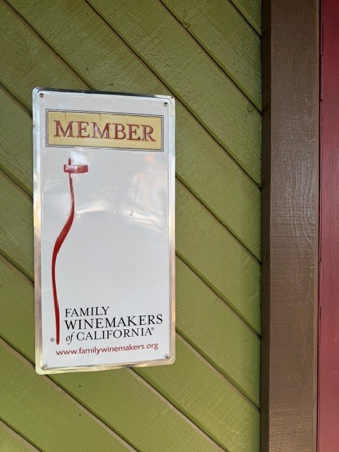 A Family Winemakers of California member sign on the winery's green wall