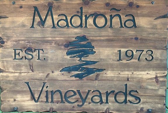 A carved wooden sign reading Madroña Vineyards, Est. 1973, with the madrone tree logo.