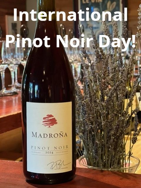 A bottle of Madroña Pinot Noir on the tasting bar beside a vase of dried lavender. Text on the photo reads International Pinot Noir Day!
